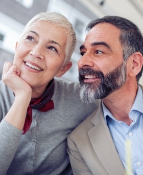 Older man and woman smiling together