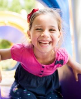 Young girl smiling on a playground