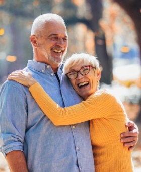 Man and woman laughing and hugging