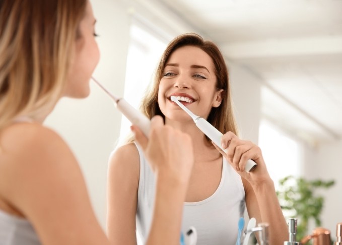 Young woman brushing her teeth