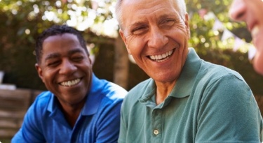 Group of men laughing together outdoors