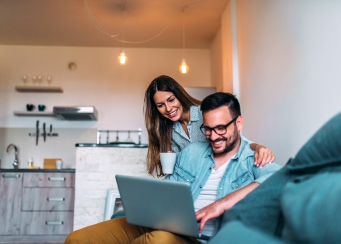 Man and woman looking on laptop at dentist reviews in Bedford