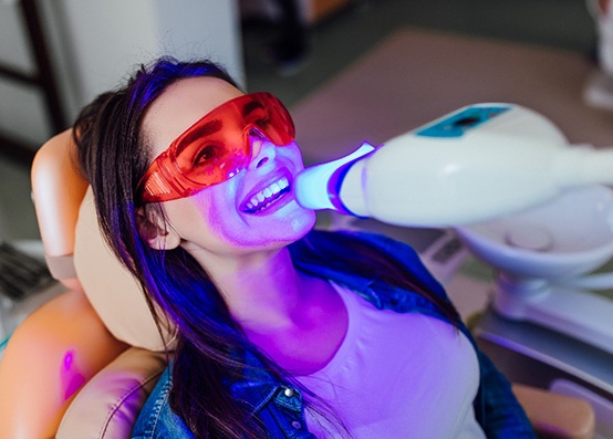 Woman in Bedford brushing her teeth after teeth whitening