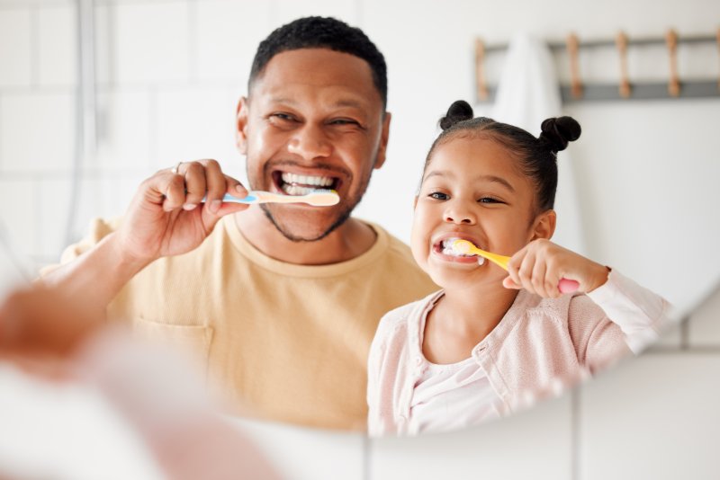 Patient and child doing oral care together